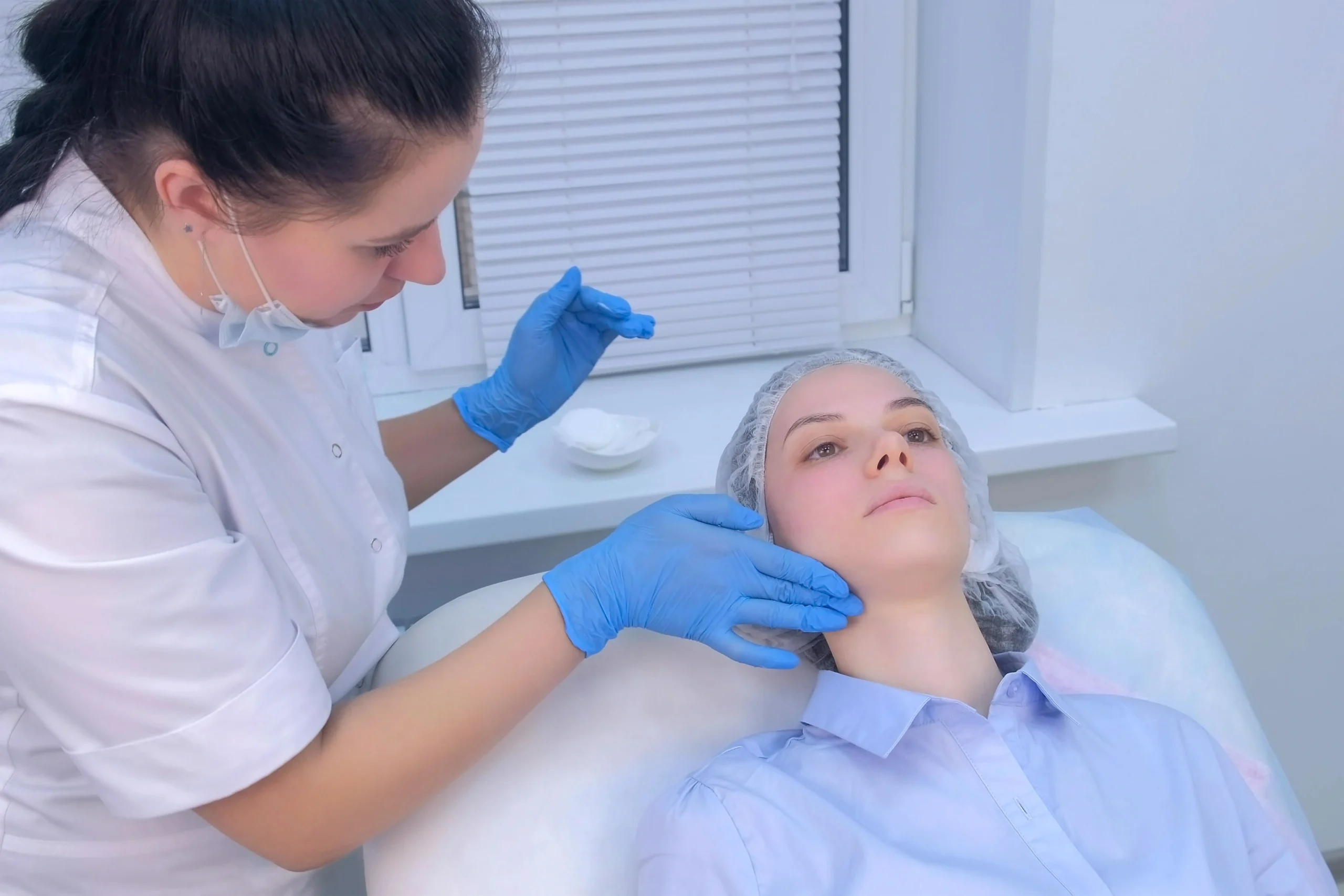 Aesthetic provider applying a growth factor skin treatment to a patient’s face in Evans, GA